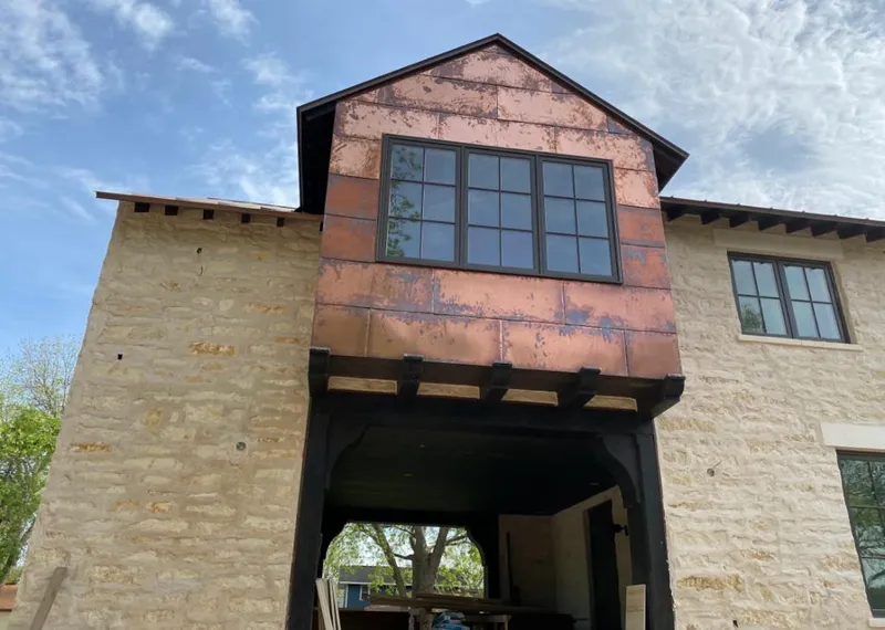Copper metal panel facade on a stone building for Skylight Installation in Bernards